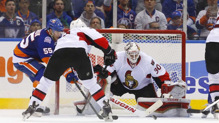 Andrew Hammond of the Ottawa Senators defends his net in the second period against Johnny Boychuk of the New York Islanders at Nassau Coliseum on Friday, March 13, 2015.