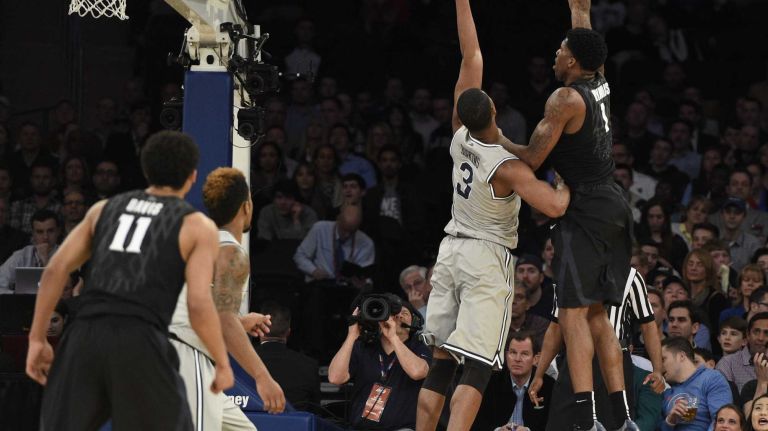 Big East Tournament semifinal: Georgetown vs. Xavier 52 Xavier Musketeers forward Jalen Reynolds sinks his layup past Georgetown Hoyas forward Mikael Hopkins in a Big East semifinal men's basketball game at Madison Square Garden on Friday, March 13, 2015.