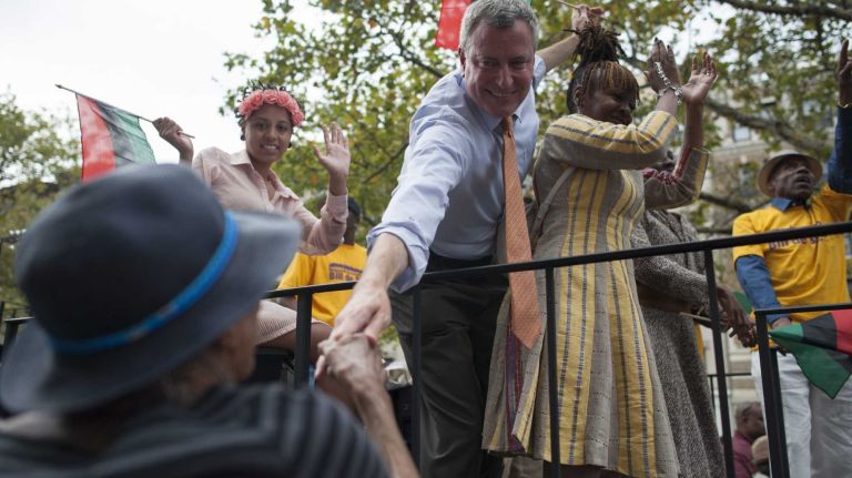 Democratic mayoral candidate Bill de Blasio and his family ride a float during the annual African American Day Parade in Manhattan. (Sept. 15, 2013)