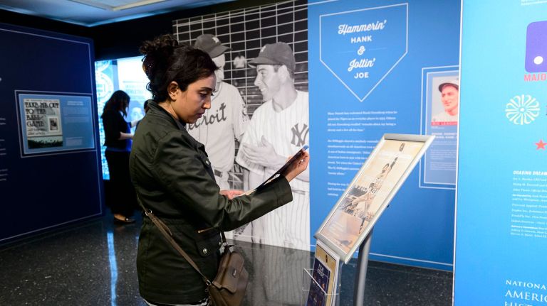 Sama Jan, a member of the New York Adventure Club, checks out the new, interactive baseball exhibit at the American Jewish Historical Society on West 16th Street in Manhattan on Tuesday, April 26, 2016.
