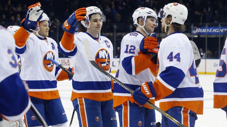 Kyle Okposo #21, John Tavares #91, Josh Bailey #12 and Calvin de Haan #44 of the New York Islanders celebrate after defeating the New York Rangers at Madison Square Garden on Tuesday, Jan. 13, 2015.