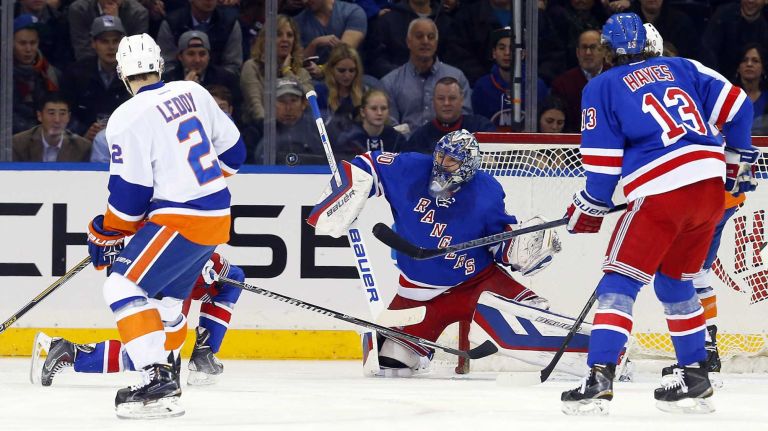 Henrik Lundqvist #30 of the New York Rangers makes a first-period save on a shot from Nick Leddy #2 of the New York Islanders at Madison Square Garden on Tuesday, Jan. 13, 2015.