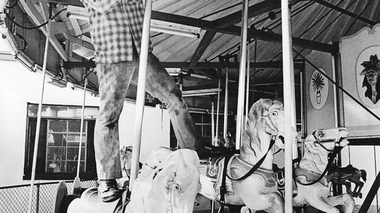 Mechanic Michael Magro, of Rockaway, works on the merry-go-round at Rockaways' Playland on July 29, 1977.