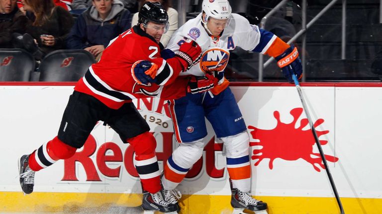 Marek Zidlicky of the New Jersey Devils hangs on to Kyle Okposo of the New York Islanders during the first period at the Prudential Center on Jan. 9, 2015 in Newark, N.J.
