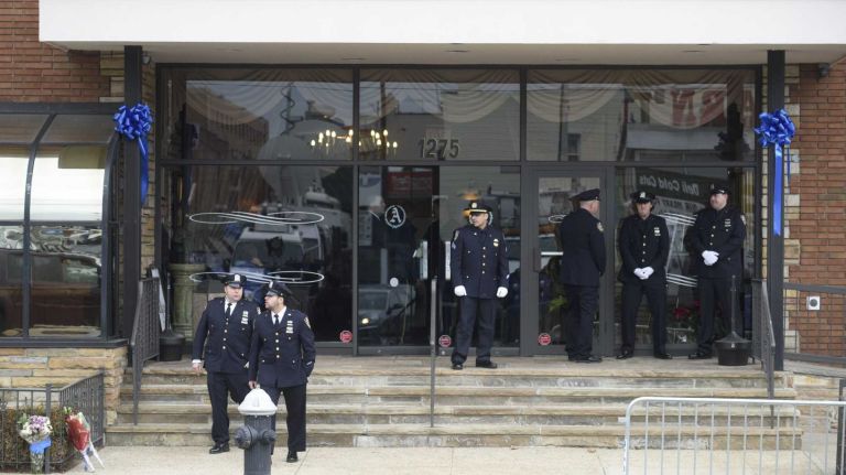 City police arrive at the Aievoli Funeral Home in Brooklyn for the wake of Det. Wenjian Liu on Jan. 3, 2015. Liu and his partner, Rafael Ramos, were promoted to detective posthumously after they where shot and killed in their patrol car last month.