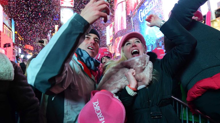 Dennis Brown and Sheridan Nichols of Tennessee watch the ball drop in New York's times square as they ring in the New Year at midnight on New Years Eve. January 1, 2015