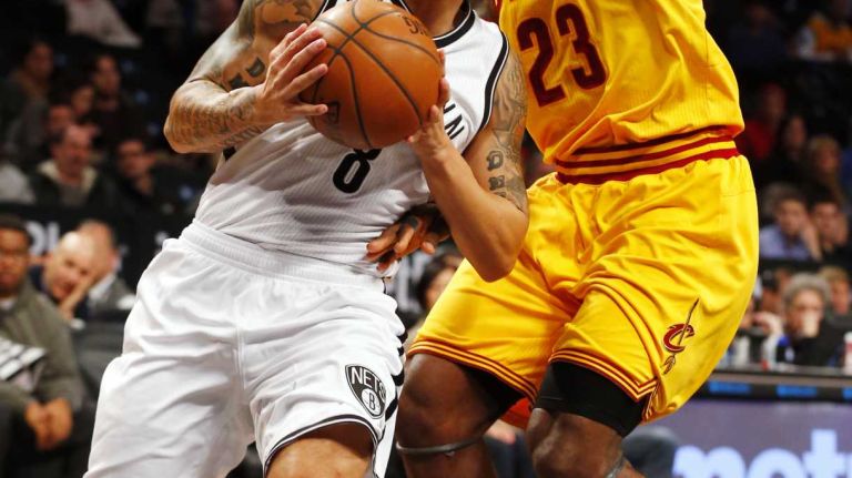 Deron Williams #8 of the Brooklyn Nets drives against LeBron James #23 of the Cleveland Cavaliers in the first quarter at Barclays Center on Monday, Dec. 8, 2014.