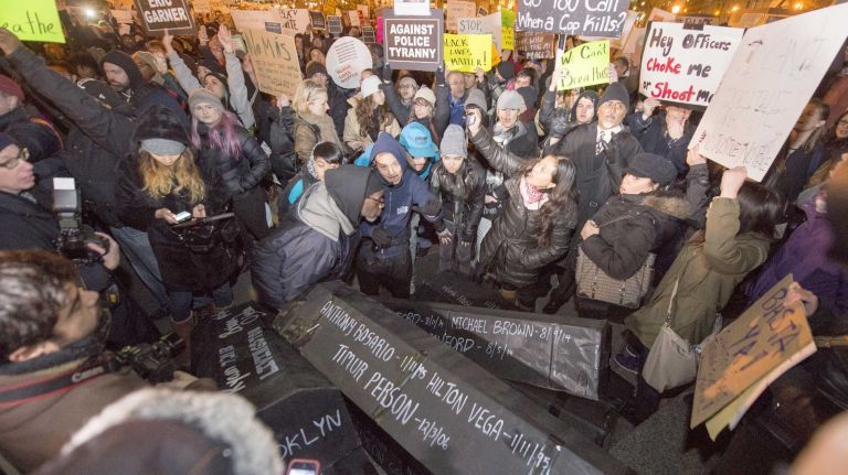 Make-shift coffins are laid out in front of a large crowd that demonstrated at Foley Square in New York City Thursday, Dec. 4, 2014 after a Staten Island grand jury decided not to indict NYPD officer Daniel Pantaleo in the death of Eric Garner on July 17, 2014.