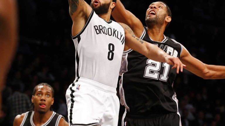 Deron Williams of the Brooklyn Nets goes to the hoop for a third quarter basket against Tim Duncan of the San Antonio Spurs during an NBA game at Barclays Center on Wednesday, Dec. 3, 2014.