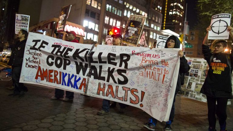 People gather at Union Square in Manhattan Monday, Nov. 24, 2014, as they await for word if a grand jury will recommend charges against Ferguson officer Darren Wilson who shot and killed an unarmed Michael Brown in August, sparking violent protests in Ferguson, Mo.