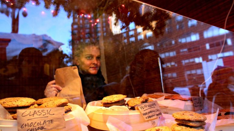 Sarah Hoogenboom from Brooklyn, left, works the Rubyzaar Baked booth at the Union Square Holiday Market, Friday, Nov. 21, 2014.
