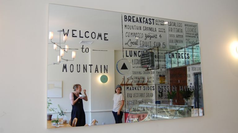 MOUNTAIN Crown Heights is open and inviting upon first entering. You can get food from the Apothecary Kitchen to go, or enjoy it at a communal wooden table. 