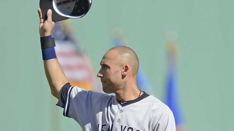 The Yankees' Derek Jeter waves to the crowd during a ceremony to commemorate him before the start of the last game of his career against the Boston Red Sox at Fenway Park on Sept. 28, 2014.