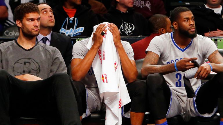 From left, Brook Lopez, Markel Brown and Willie Reed of the Brooklyn Nets sit on the bench late in a game against the New Orleans Pelicans at Barclays Center on Sunday, April 3, 2016.