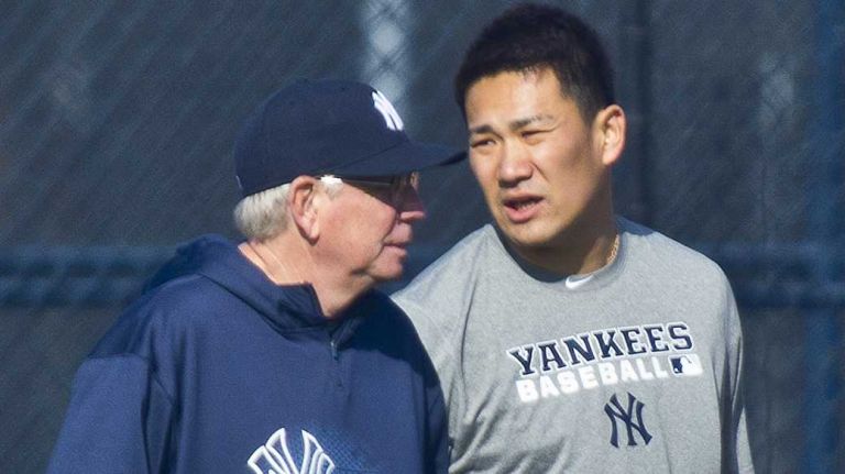 Yankees' Masahiro Tanaka walks with pitching coach Larry Rothschild as he works out at the team's minor-league facility in Tampa, Fla. on the morning of Feb. 13, 2014, prior to the official start of spring training.