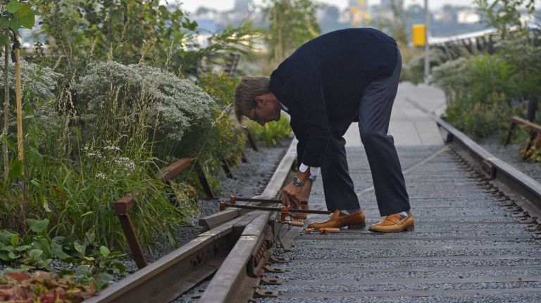 High Line photos: Final section of the park opens 29 Jonathan Yeadon, a project manager from Sciame Construction Co. Inc., puts some finishing touches on the expanded High Line at the Rail Yards prior to an opening ceremony in Manhattan on Saturday, Sept. 20, 2014.