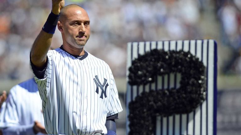 Yankees shortstop Derek Jeter waves to the crowd at Yankee Stadium during Derek Jeter Day on Sunday, Sept. 7, 2014