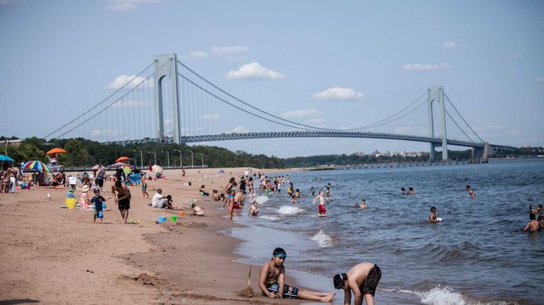 People on the beach near the Verrazano Bridge.