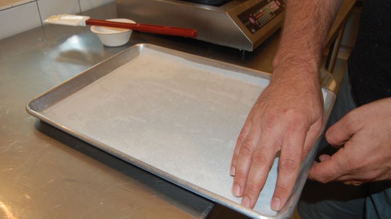 Butter a 12-by-18-inch rimmed baking sheet and line it with parchment paper.