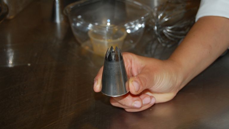 A size 13 star tip makes the perfect size macaroons. (Note: you can use any size or even a spoon to dollop out the mixture onto a cookie tray, but if you want perfectly shaped macaroons, this is the way to go.)