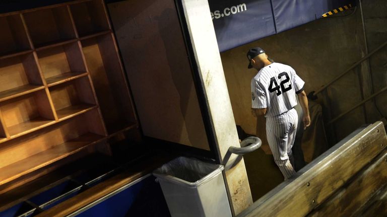 New York Yankees pitcher Mariano Rivera leaves the field for the last time as a player at the close of his last game at Yankee Stadium on Sept. 26, 2013. With two outs left in the ninth and the Yankees up 2-1 on the Houston Astros, Derek Jeter and Andy Pettitte emerged from the dugout to take Rivera out of the game.