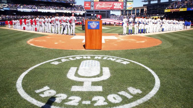 The Mets and the Washington Nationals stand on the baselines for the national anthem at Citi Field on Monday, March 31, 2014.