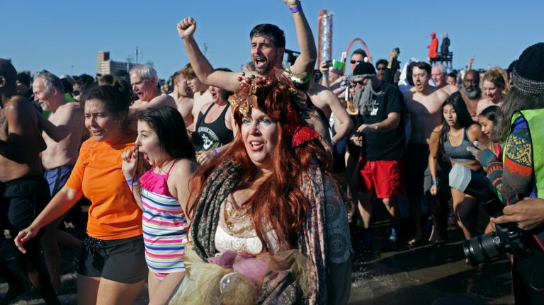 Swimmers run into the ocean during the Coney Island Polar Bear Club's New Year's Day Swim on Jan. 1, 2017.