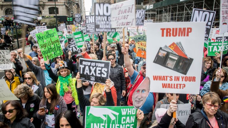 Protesters gather outside Bryant Park to call for President Donald Trump's tax returns on Saturday, April 15, 2017.
