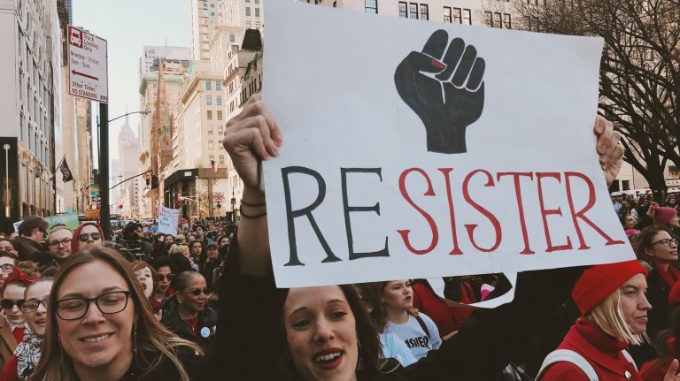 A woman holds a protest sign during the A Day Without a Woman rally in Manhattan on March 8, 2017.