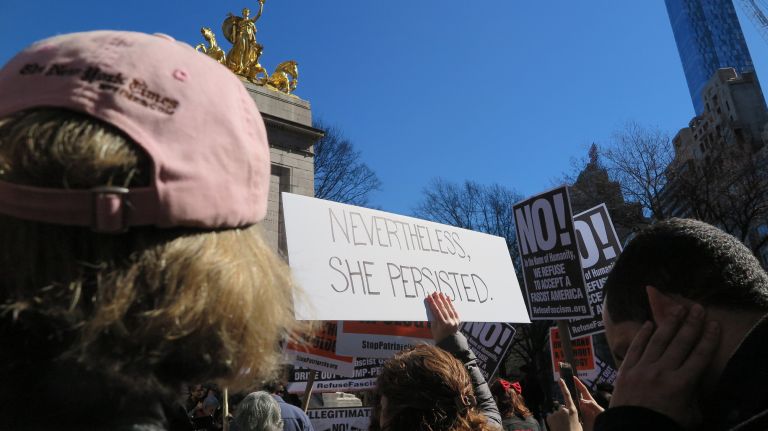 A woman holds a protest sign during the A Day Without a Woman rally in Manhattan on Wednesday, March 8, 2017.