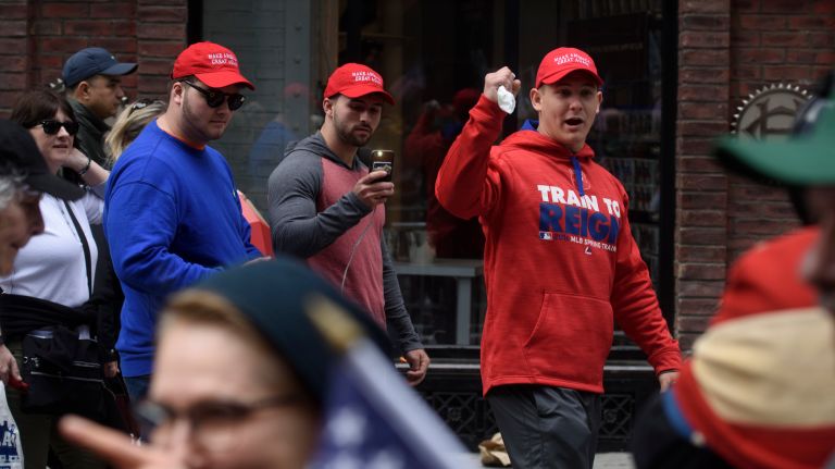 Trump supporters walk past the I Am A Muslim Too rally in Times Square on Feb. 19, 2017.