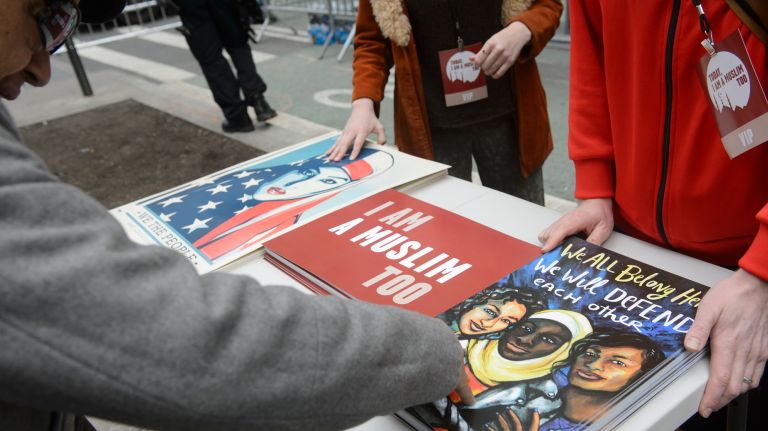 Signs are distributed at the I Am A Muslim Too rally in Times Square on Feb. 19, 2017. 