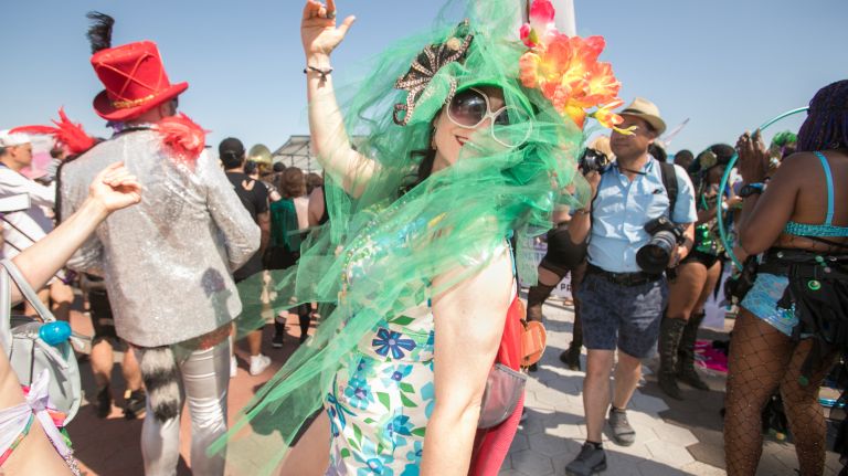 A mermaid dances on the boardwalk.