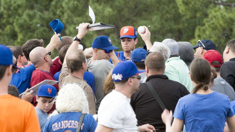New York Mets pitcher Steven Matz signs autographs during a spring training workout on Sunday, Feb. 21, 2016 in Port St. Lucie, Fla.