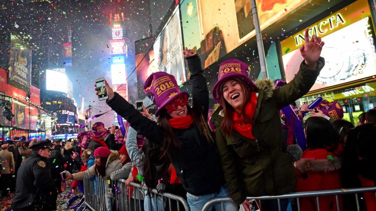 New Year's Eve in NYC 2015 to 2016: Pictures of the ball drop in Times Square and more 24 New Year's Eve revelers Ayaka Tsutsnmi and Yurina Yasutomi of Japan celebrate at midnight as they ring in 2016 in Times Square, Friday, Jan. 1, 2016.