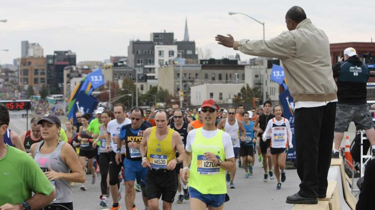 The Rev. Anthony DeOliveira blesses participants in the New York City Marathon in Brooklyn on Nov. 1, 2015.