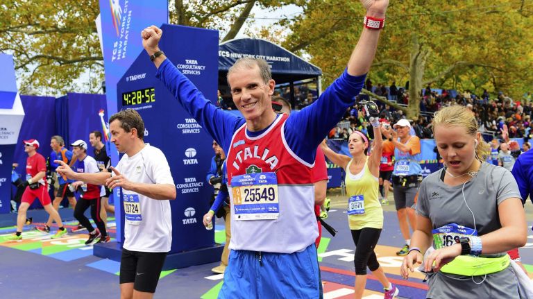 Runners celebrate at the finish line of the New York City Marathon in Manhattan on Sunday, Nov. 1, 2015.