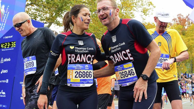 Runners react at the finish line of the New York City Marathon in Manhattan on Sunday, Nov. 1, 2015.