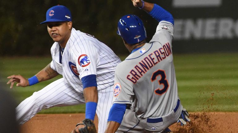 New York Mets right fielder Curtis Granderson (3) steals second base on Chicago Cubs shortstop Starlin Castro (13) in the first inning during Game 4 of the NLCS against the Chicago Cubs at Wrigley Field on Wednesday, Oct. 21, 2015.