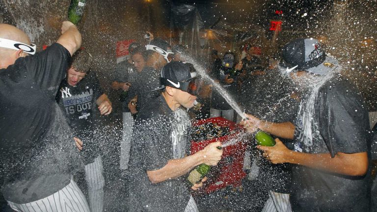 The New York Yankees celebrate in the locker room after defeating the Boston Red Sox at Yankee Stadium on Thursday, Oct. 1, 2015.