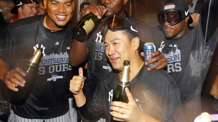 Masahiro Tanaka of the New York Yankees celebrates in the lockerroom after defeating the Boston Red Sox with teammates Ivan Nova, Michael Pineda and Luis Severino at Yankee Stadium on Thursday, Oct. 1, 2015.