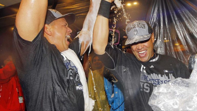 Carlos Beltran and Alex Rodriguez of the New York Yankees celebrate in the locker room after defeating the Boston Red Sox at Yankee Stadium on Thursday, Oct. 1, 2015.