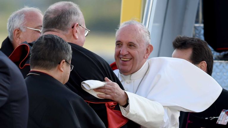Pope Francis is greeted by Cardinal Timothy Dolan and Bishop Nicholas DiMarzio as he arrives at Kennedy Airport in Queens on Thursday, Sept. 24, 2015.