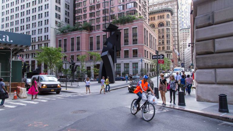 Pedestrians pass a public art installation in Manhattan's Financial District on Aug. 20, 2015.