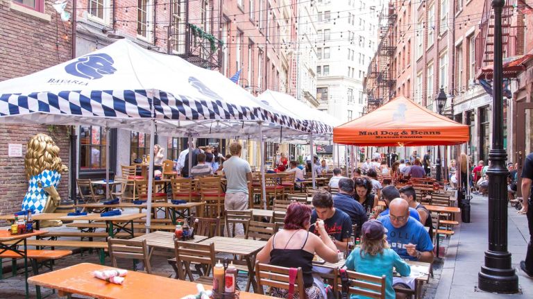 People drink and dine on Stone Street in Manhattan's Financial District on Aug. 20, 2015.