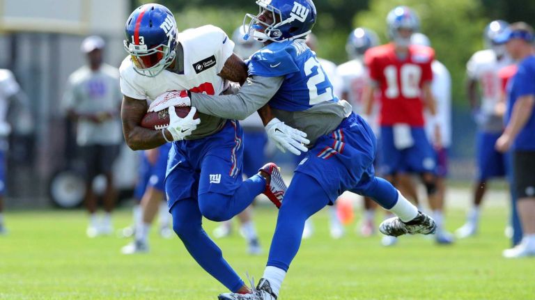 New York Giants wide receiver Odell Beckham Jr. runs the ball past cornerback Prince Amukamara during training camp at the Quest Diagnostics Training Center in East Rutherford, N.J., on Saturday, Aug. 1, 2015.