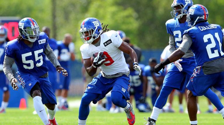 New York Giants wide receiver Geremy Davis runs the ball between linebacker J.T. Thomas, cornerback Prince Amukamara and safety Landon Collins during training camp at the Quest Diagnostics Training Center in East Rutherford, N.J., on Saturday, Aug. 1, 2015.