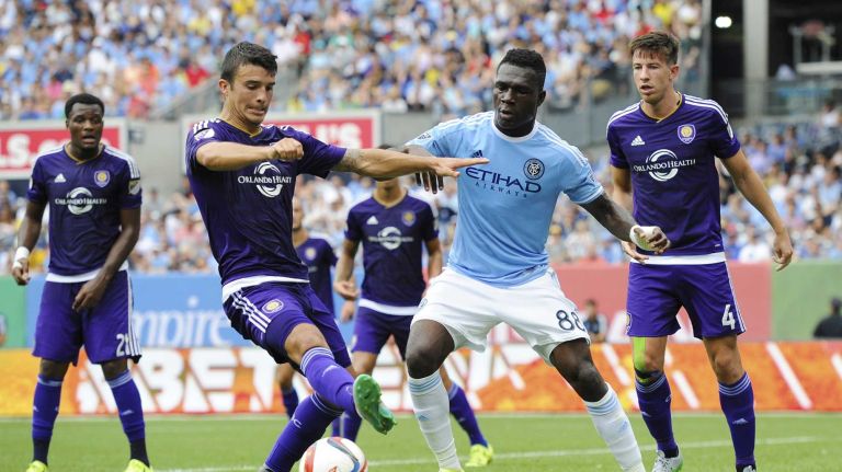 Orlando City FC midfielder/defender Servando Carrasco (5) and New York City FC midfielder Kwadwo Poku (88) battle for the ball in an MLS game at Yankee Stadium on Sunday, July 26, 2015.