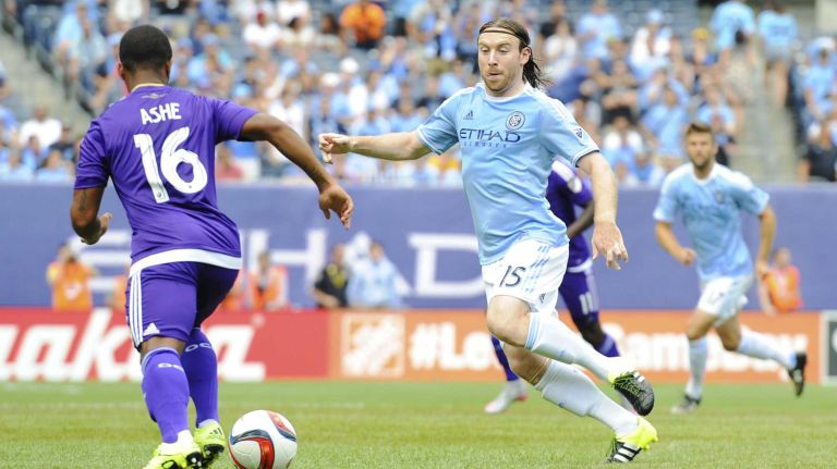 Orlando City FC defender Corey Ashe (16) is defended by New York City FC midfielder Thomas McNamara (15) in an MLS game at Yankee Stadium on Sunday, July 26, 2015.