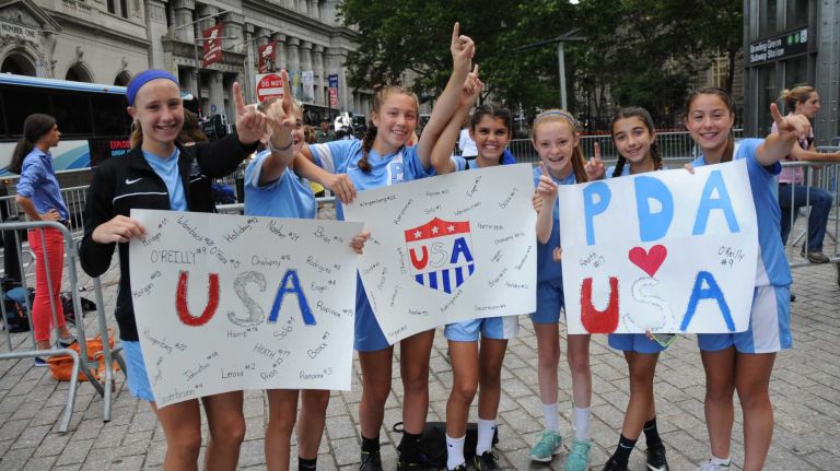 Members of the girls Players Development Academy in Zarephath, N. J., cheer as they wait for the World Cup champion U.S. Women's Soccer Team's ticker-tape parade to start along the Canyon of Heroes in lower Manhattan on Friday, July 10, 2015.